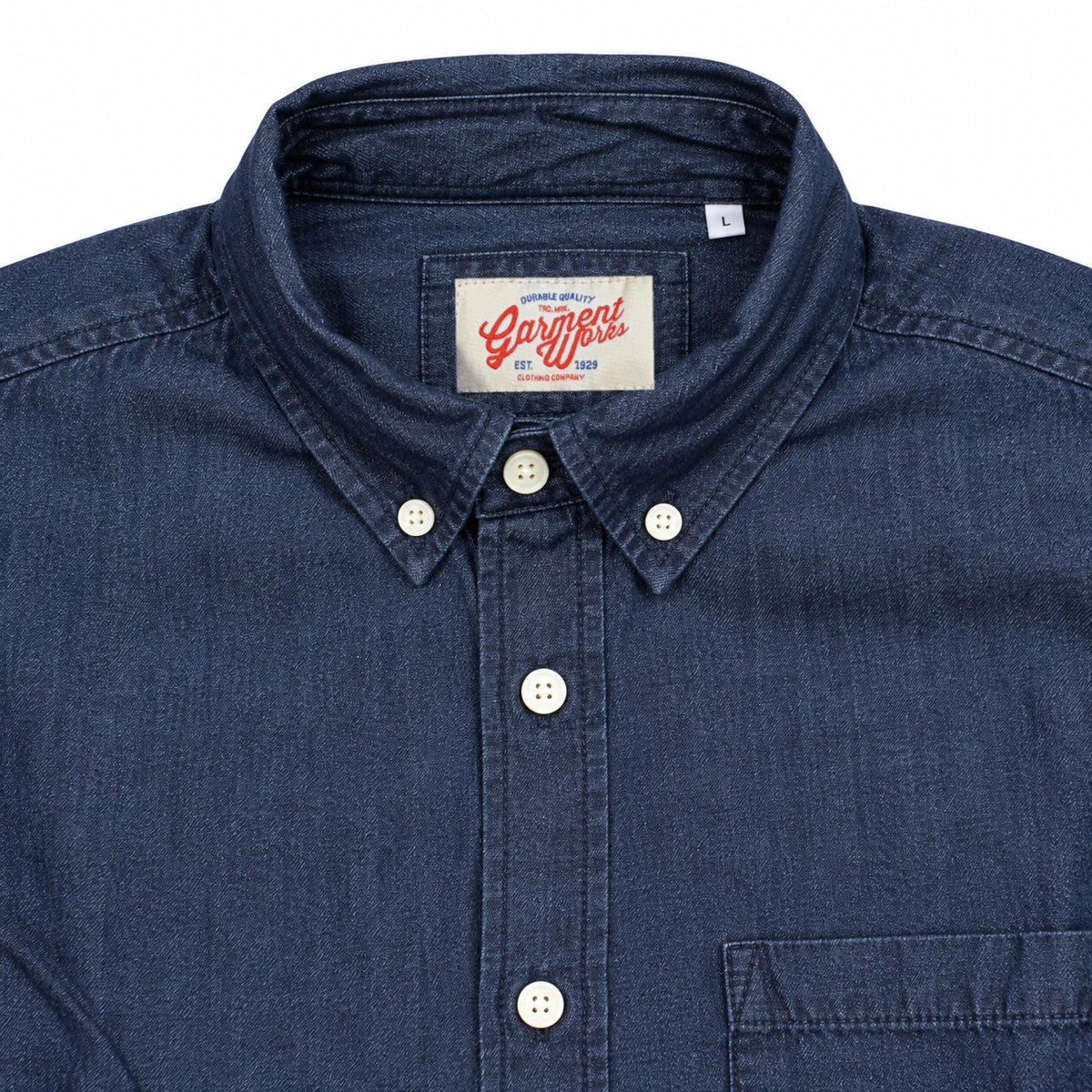 Close-up of dark denim button down collar and Garment Works woven label