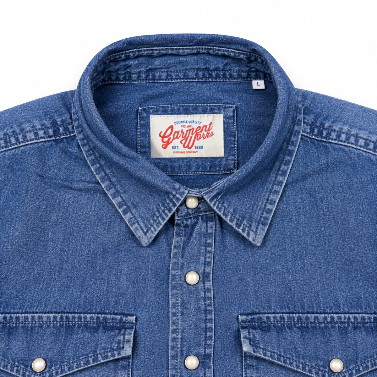 Close-up of dark denim western shirt collar, snaps and Garment Works label