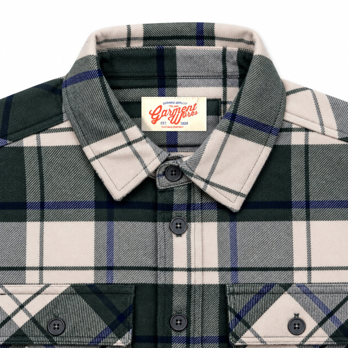 Close-up of cream and green check overshirt collar, flap pockets and Garment Works label