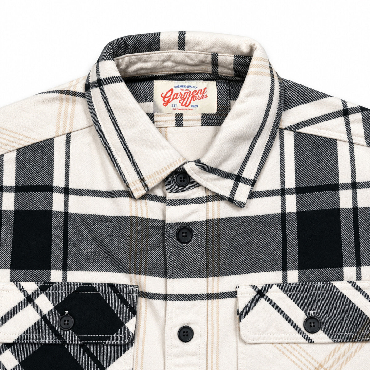 Close-up of Esco cream check overshirt collar, flap pockets and Garment Works label