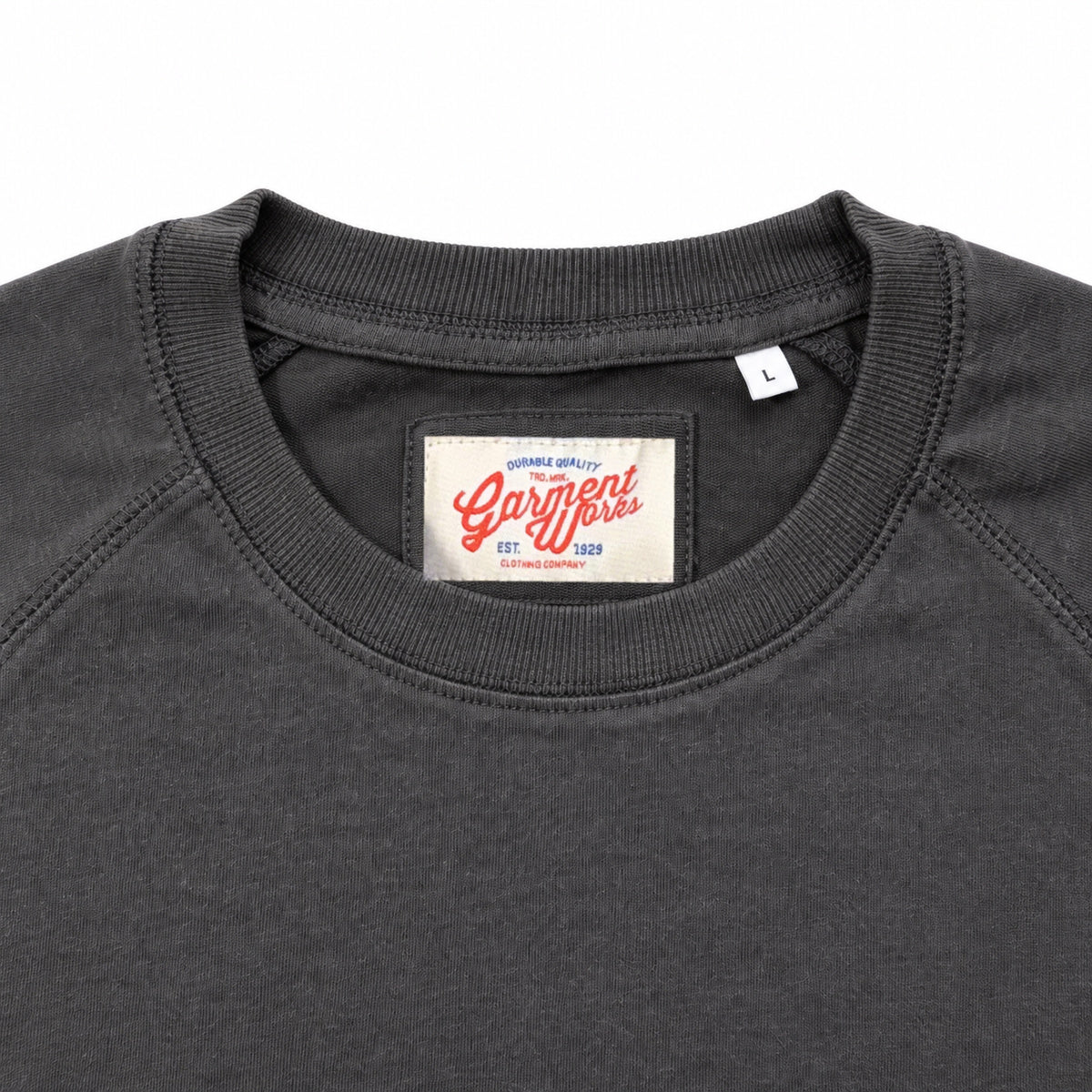 Close-up of charcoal raglan top crew neckline and Garment Works woven label