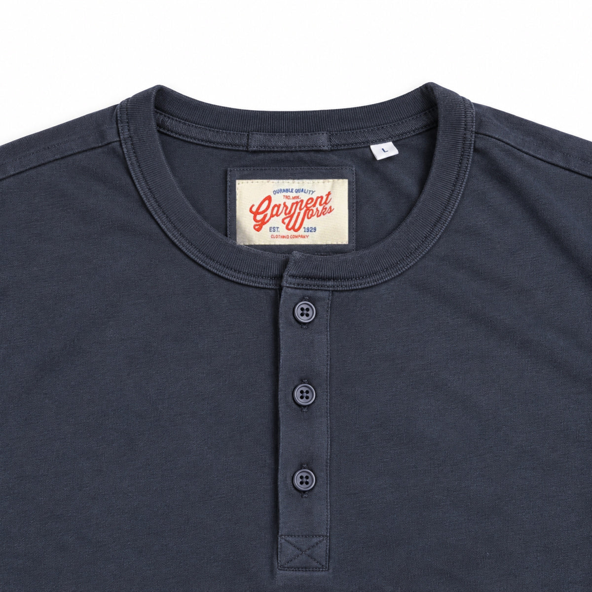 Close-up of dark ink henley neckline, button placket and Garment Works label